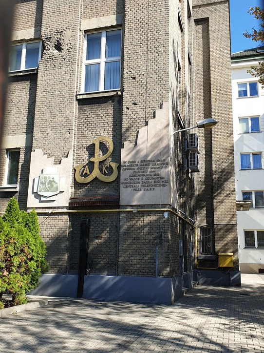 Poland - Warsaw - Telephone exchange in Praga with WWII damage and the symbol for the Polish resistance