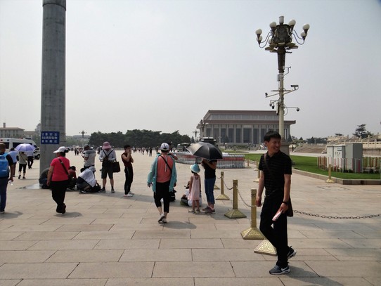 China - Beijing - It's a huge square, and in 35 degrees, people will get shade where they can.