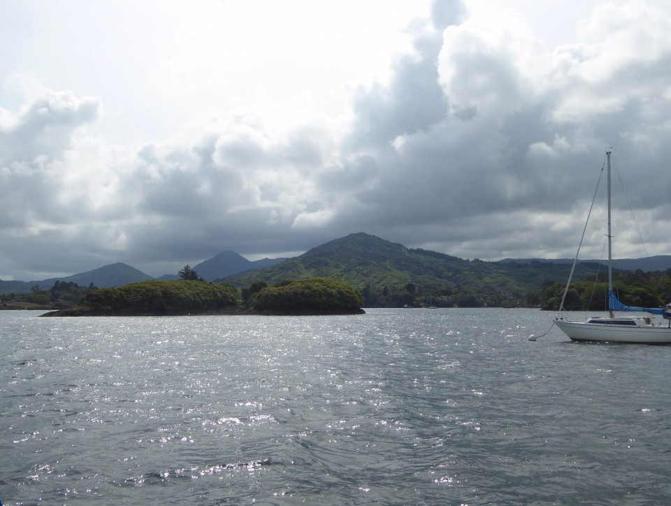 Ireland - Glengarriff - As we approached our mooring buoy the clouds started to gather and the wind increased. We were better prepared for mooring buoys without pickups here, though, and Kevin lassoed one first time.  We then used our special contraption to feed two lines through the shackle. 
 