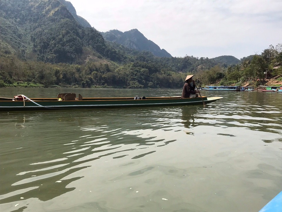 Laos -  - Our boat and guide, waiting for us to give up kayaking but we made it all the way... he just had to put the kayak on his boat and drive all the way back to Muang Ngoi