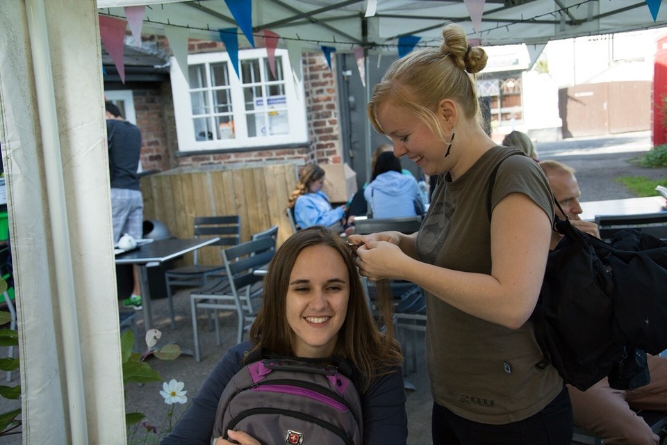 United Kingdom - Styal - Elisabeth braiding a bit of cotton into Carolyn's hair