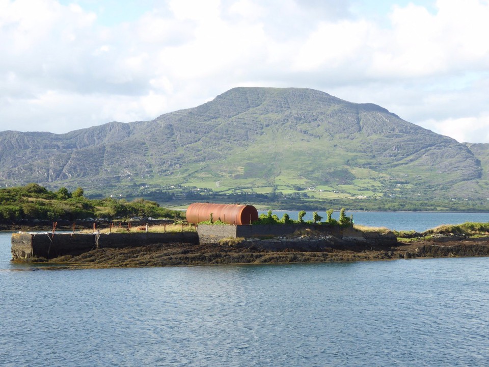 Ireland -  - A lovely welcome awaited us at Lawrence Cove from Rachael, the marina owner, and boat owners who took our lines. This rusty tank is a navigational mark for the marina entrance.