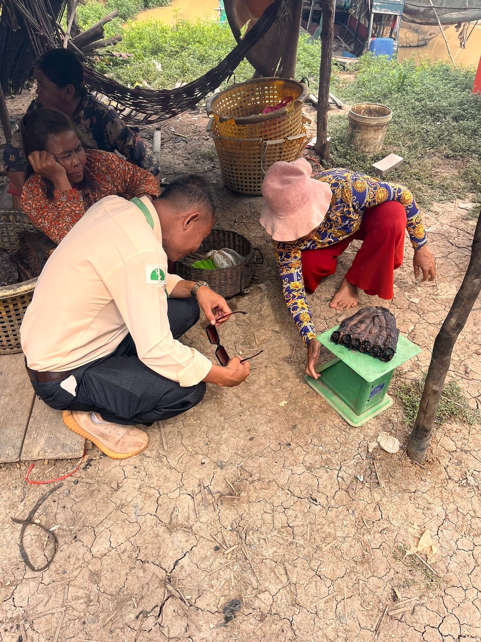 Cambodia - Siem Reap - No one else had signed up to the tour so I had Pip, the tour guide, all to myself which was great and I learnt so much. We started off by going to a local market and seeing how some of the food is cooked. Here the ladies are smoking fish. All the locals were so friendly and happy