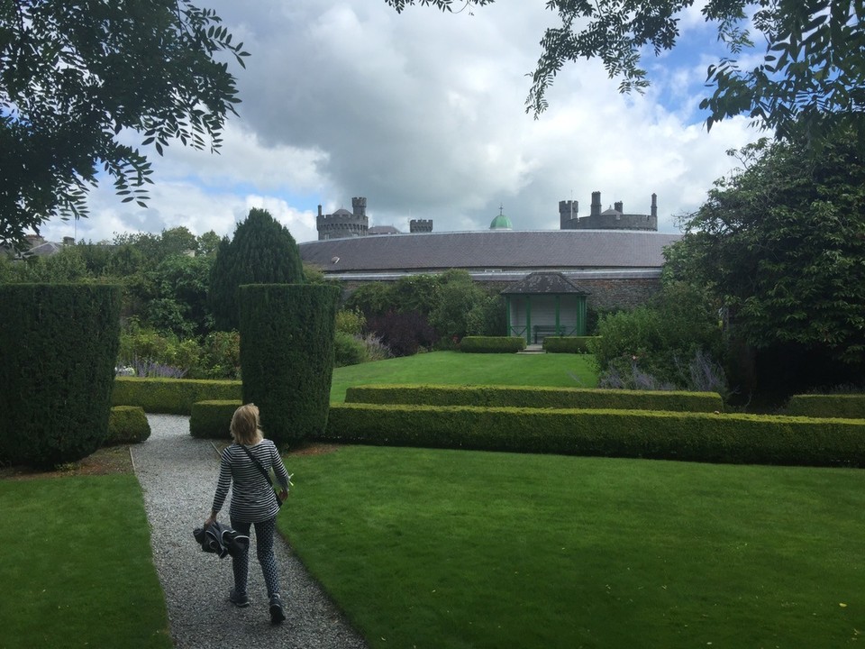 Ireland - Kilkenny - Butler family residence. Walking toward the castle stables with the castle in the background. 
The stables now house a design centre for local artists. 