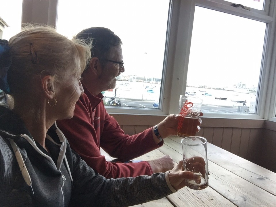  - United Kingdom, Falmouth - Grape Ale House, Irish 13 Hops Beer (Susie) and Cornish Knocker Golden Pale Ale (Ron). Our ship, MS Ocean Majesty, in the background. 