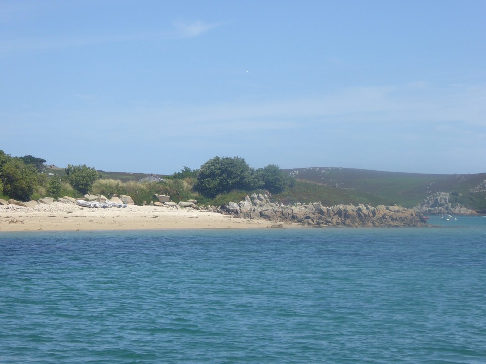 United Kingdom - Isles Of Scilly - It seemed a little weedy, but nothing was on the charts. Kevin was just beginning to have his doubts, and do some depth sounding with the boat hook to check the sea floor, when Liam and Aidan, guys who have live aboard boats here, approached in their rib to say we were probably over rocky rubble.
