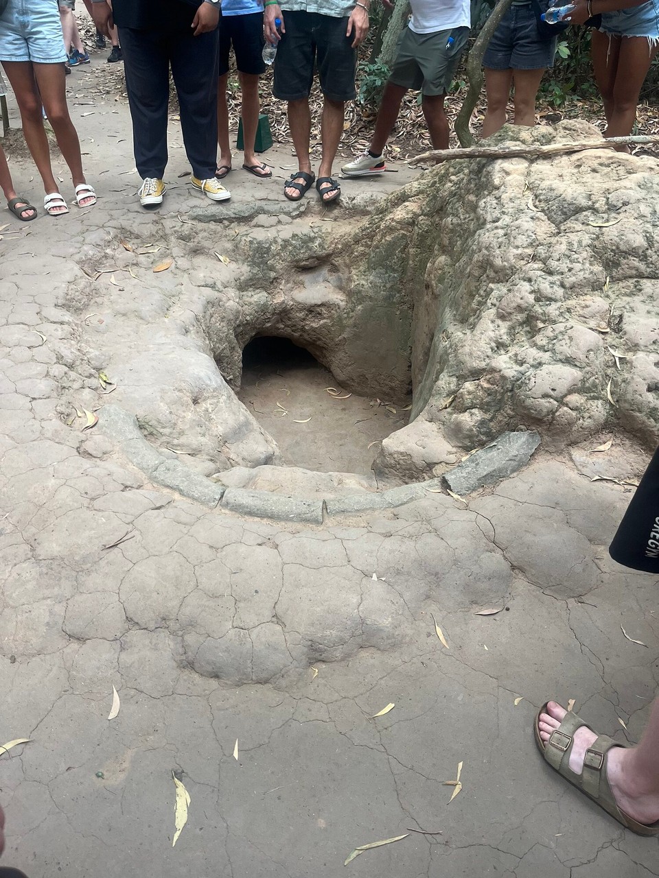Vietnam - Ho Chi Minh City - An example of the caves they would crawl down. They would then make tiny holes through these rocks for air ventilation. They dug so far down they had a water supply and also had a kitchen and meeting rooms under there