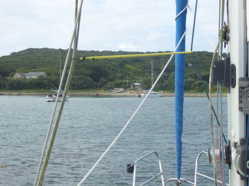 United Kingdom - Isles Of Scilly - A beautiful bay with a boat house tucked in the corner.