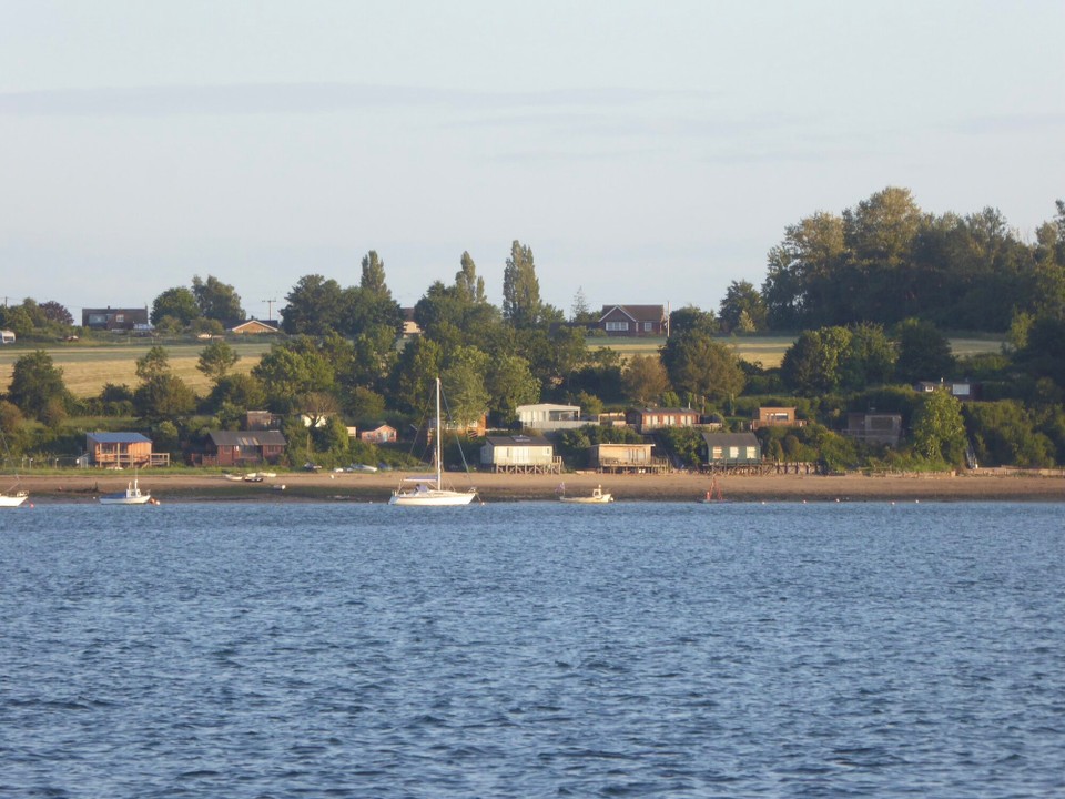 United Kingdom - Ipswich - The beach houses on Wrabness beach.