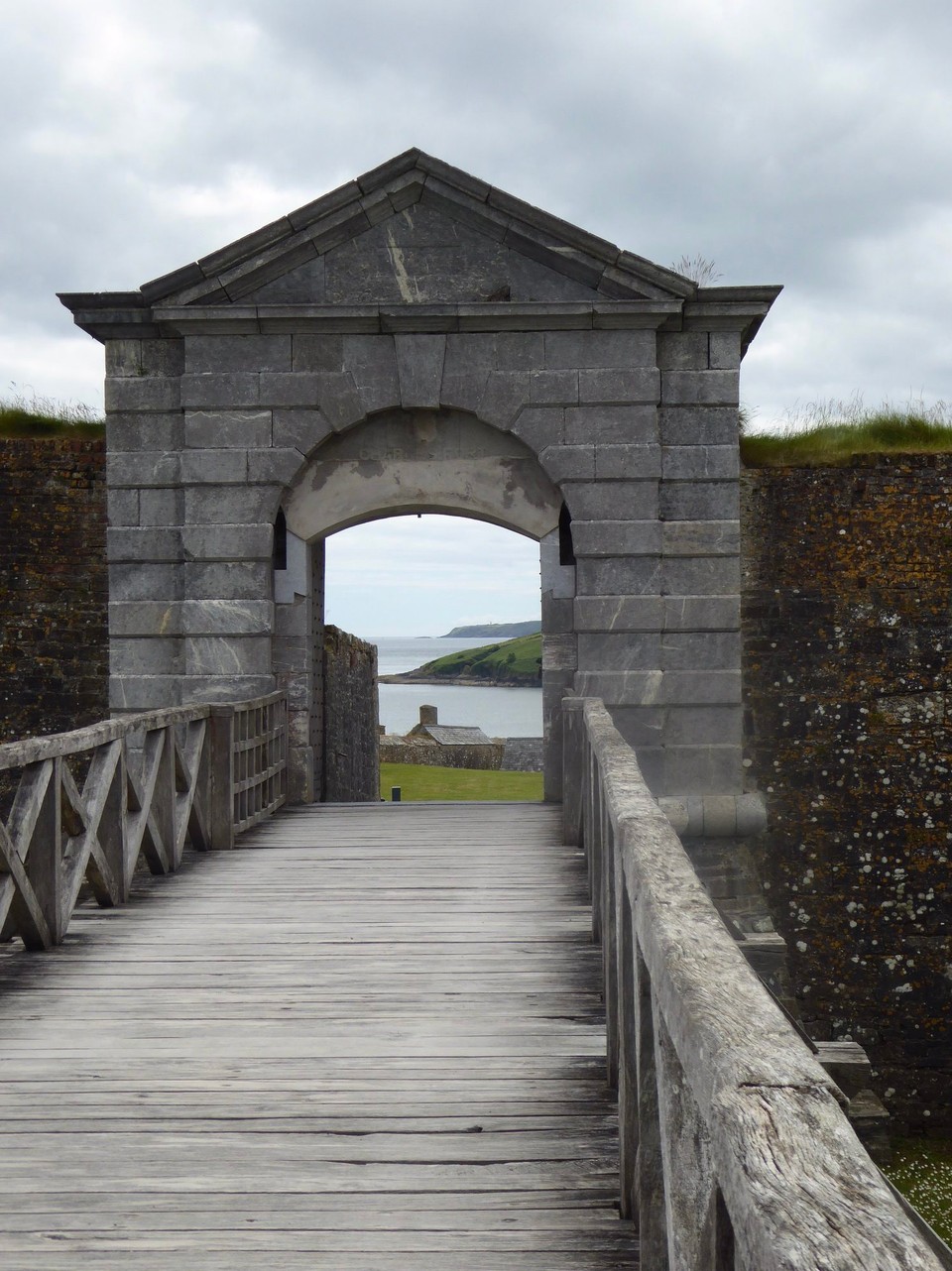 Ireland - Kinsale - A bridge goes over a dry moat to the gate of Charles’ Fort. Unless there is running water to stop the moat stagnating and smelling bad, a dry moat was always built.