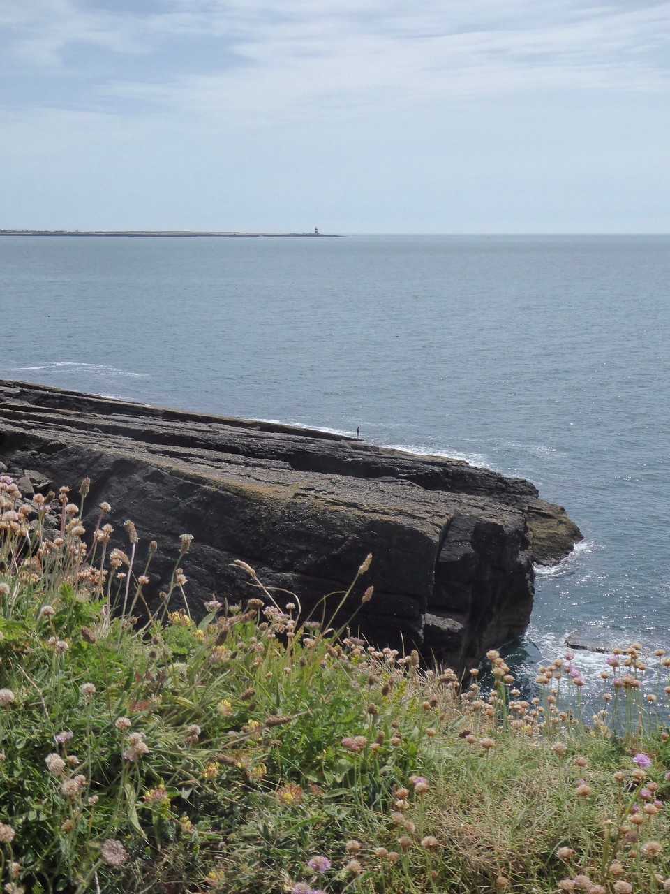 Ireland - Dunmore East - A view over to Hook Head with its Norman lighthouse, the oldest operating light tower in the world.