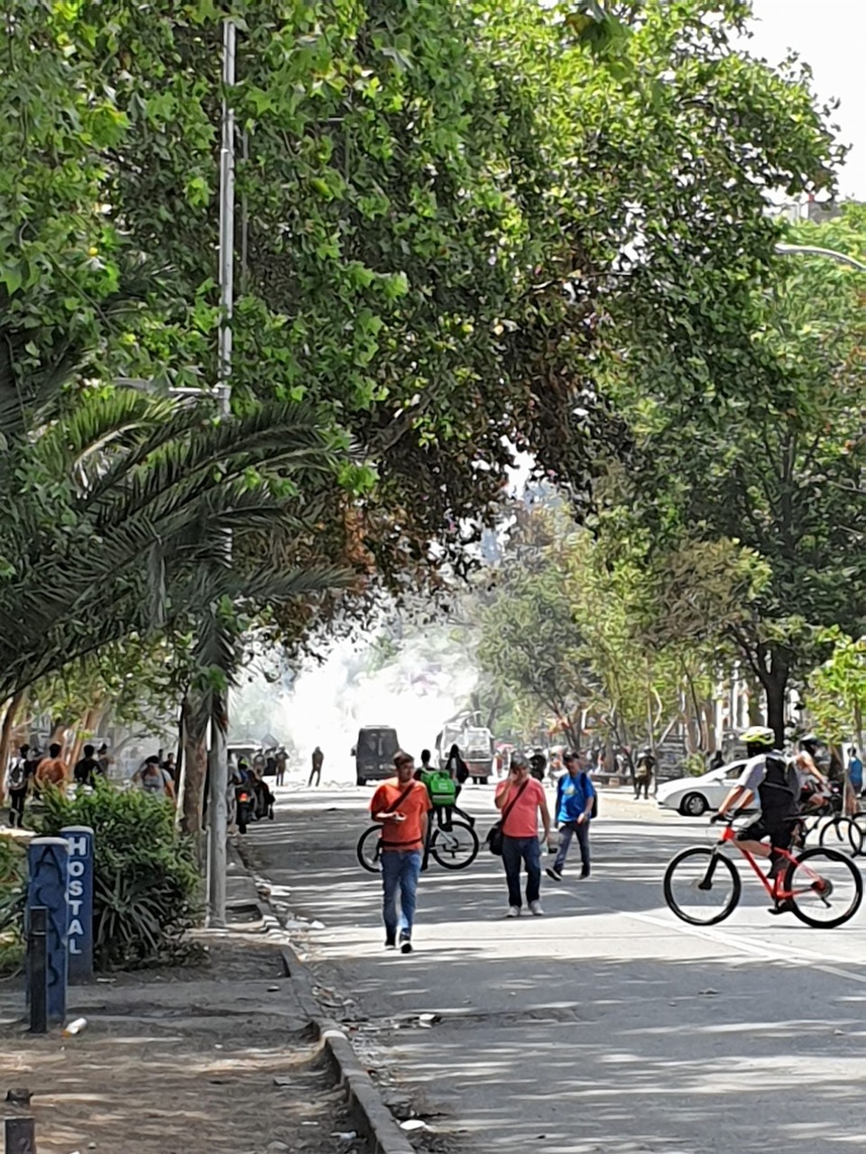 Chile - Santiago - Standing outside our hostel (sign bottom right) watching the protest