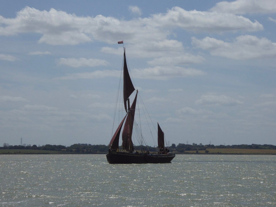 United Kingdom - Southminster - Leaving Maldon with guests, Thames sailing barge Pudge. Used by the London and Rochester Trading Co to carry various cargoes, her last cargo in 1968 was pineapple juice. Built in 1922, she is one of four Dunkirk Spritsail Barges to survive, and is therefore entitled to fly the flag of St George. 