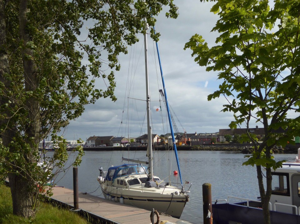 Ireland - Arklow - Avalon on the river pontoon in Arklow, flying the Irish courtesy flag. Although a little rockier than the marina, sailors prefer the river pontoons as the marina is small and difficult to manoeuvre in because it is so crowded.