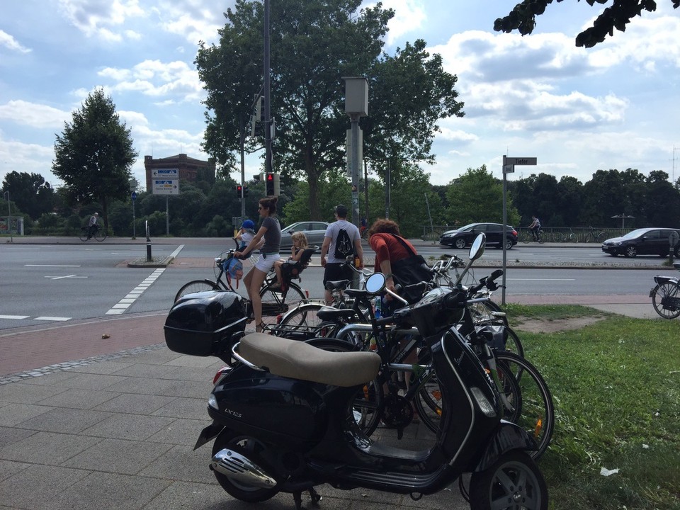  - Germany, Bremen - Bicycles everywhere in Bremen and they have right if way. This mum has 2 children on her bicycle. 