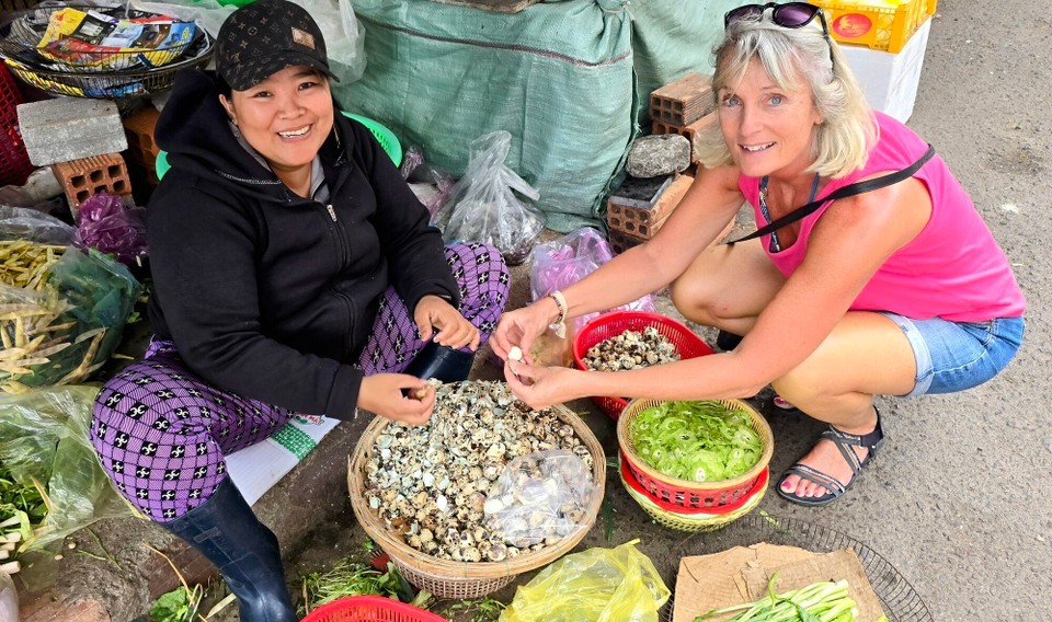Vietnam - Song Cau - Peeling quails eggs in the market at Quy Hnon