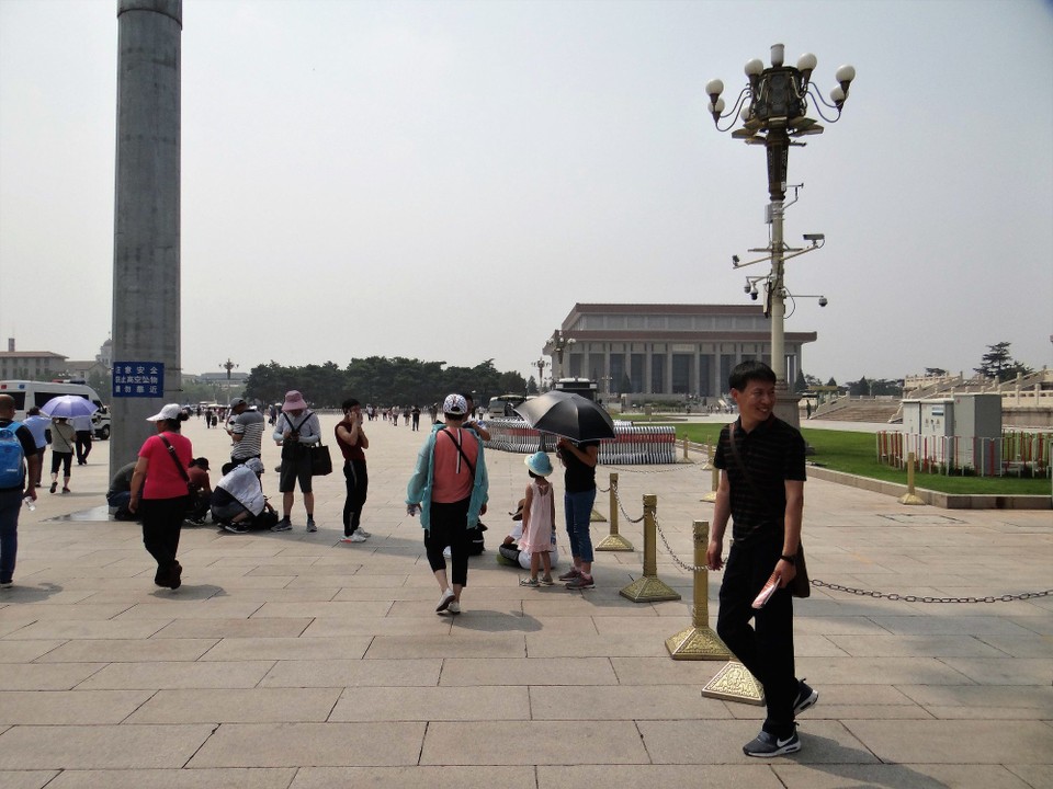 China - Beijing - It's a huge square, and in 35 degrees, people will get shade where they can.