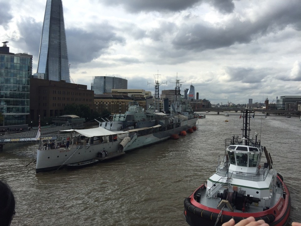  - United Kingdom, London, River Thames - The Shard building on the left. Being pulled in backwards by two tugs. 