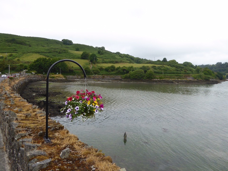 Ireland - Glandore - A road bridge shortens the creek, which is decorated with beautiful hanging baskets.