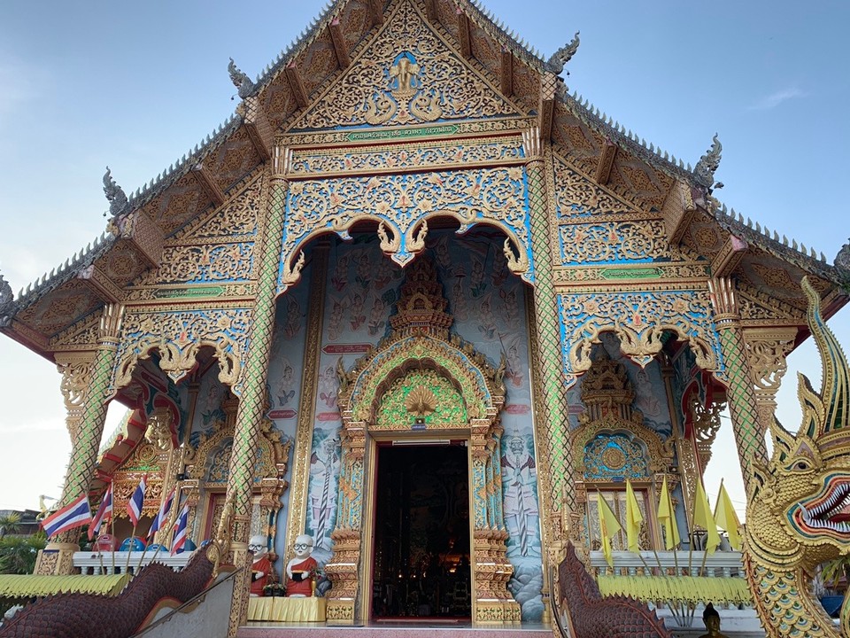 Thailand - Chiang Rai - Temple in Chiang Khong with shinny dragon exterior. There is also a very little Temple next door to the main building.