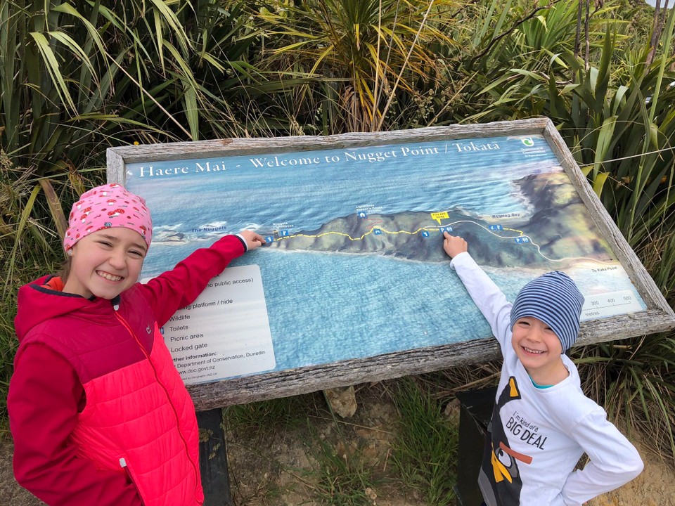 Neuseeland - Ahuriri Flat - Am Parkplatz vom Nugget Point. Nicolas zeigt wo wir sind und Lara wo wir hingehen.