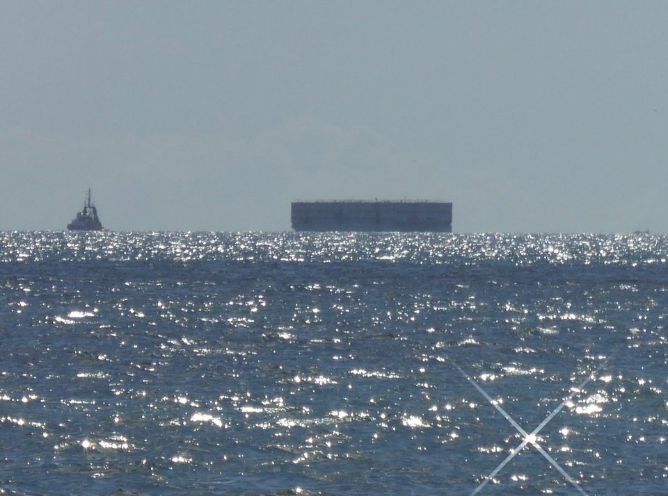 United Kingdom - St Austell - On the horizon we could see a large box-like structure, but with no AIS. From the news we discovered it is the Bibby Stockholm, which has had a refit in Falmouth, and is being towed by tugs to Portland Port, Weymouth. 