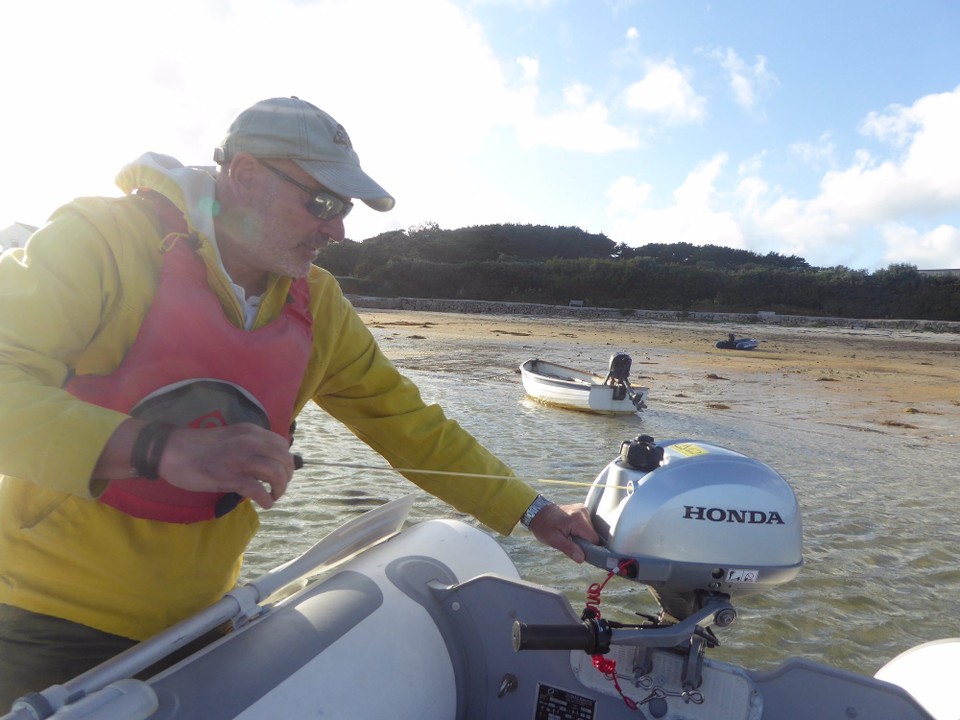 United Kingdom - Isles Of Scilly - Starting the engine before jumping into the dinghy and returning to Avalon. A choppy, wet journey.