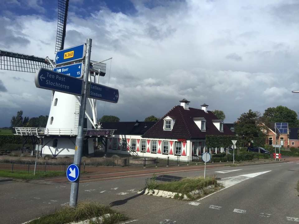 Netherlands - Groningen - Dutch windmill and houses. 