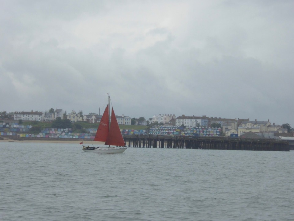 United Kingdom - Chelmsford - Lovely to see red sails against the colourful huts of Walton, to brighten up the day.